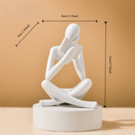 figurine deco moderne or noir blanc personne assise livre socle chambre abstraction minimalisme