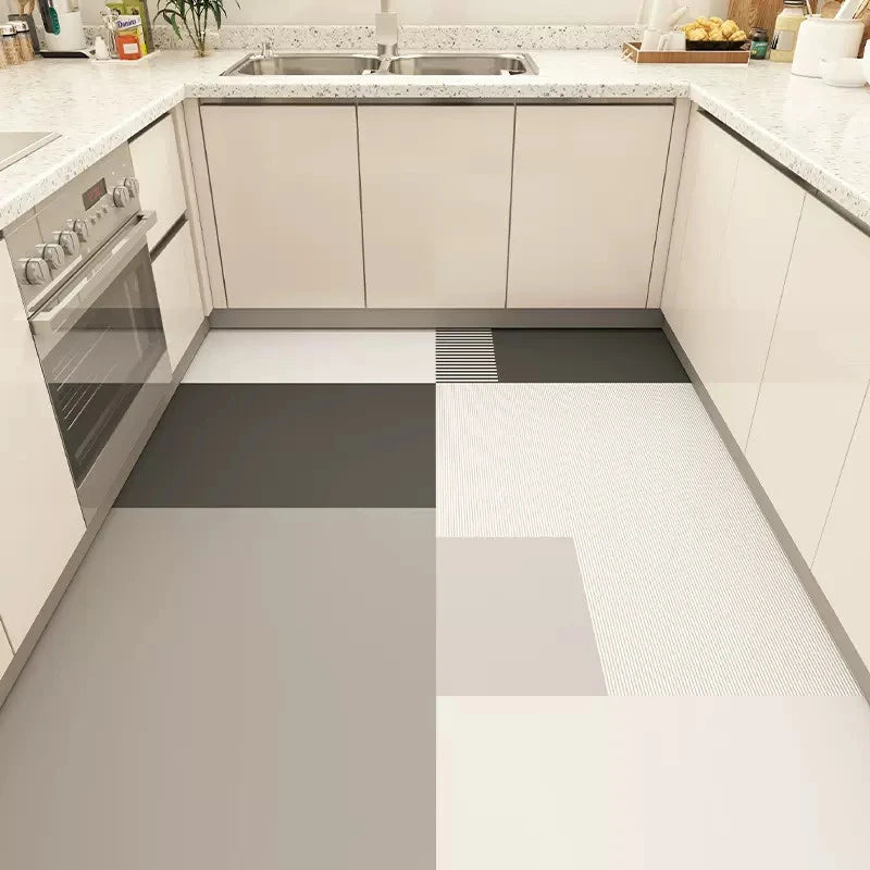 Cette image montre un intérieur de cuisine moderne avec des armoires blanches, un plan de travail en granite et un sol carrelé dans des tons gris.