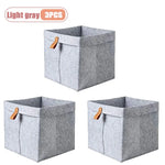 boîte rangement tissu veloutée gris clair foncée moderne pliable articles divers serviettes blanches broderie
