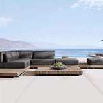 canapé extérieur modulable gris foncé tissu bois naturel coussins pieds noirs moderne minimaliste