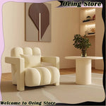 fauteuil moderne tissu texturé beige jaune marron clair coussin décoratif salon minimaliste