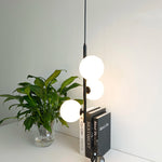 suspension lumineuse moderne sphères translucides barre métallique brillante blanc doré minimaliste chambre salon