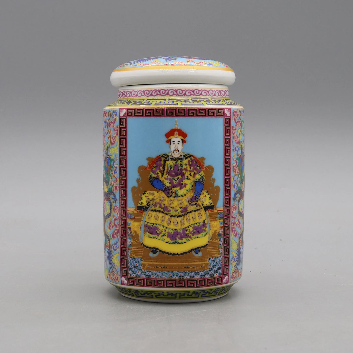 Une boîte en porcelaine décorée d'un homme vêtu de vêtements traditionnels chinois dans un style coloré et ornemental.