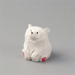 statue animale bois figurine bleu rose motif floral minimaliste yeux stylisés petite deco