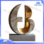 sculptures décoratives abstraites modernes or bronze marron surfaces polies aspect texturé rouille base pierre
