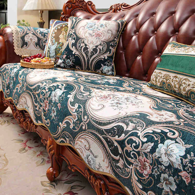 Un canapé Chesterfield capitonné avec des coussins aux motifs fleuris et damassés, créant une atmosphère élégante et raffinée dans cette pièce.