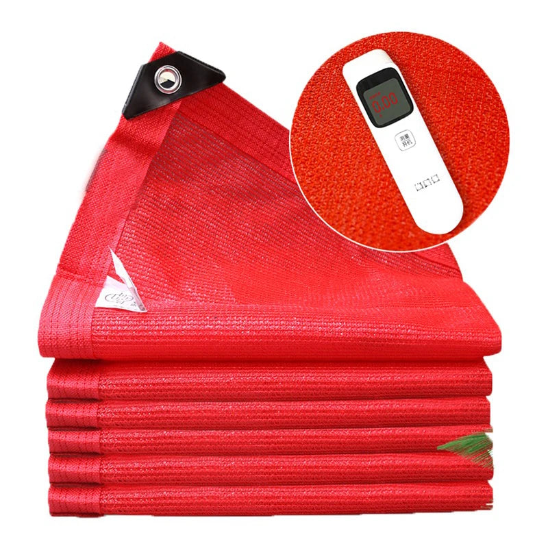 Voile d'ombrage rectangulaire rouge protégeant un coin salon extérieur