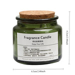 Bougie parfumée dans un bocal en verre vert avec un couvercle en liège, sur un fond blanc.