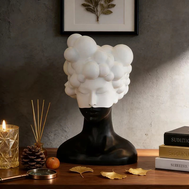 statue tête noire blanche texture mat moderne abstraite bougie concombre loupe livres lampe