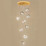 suspension lumineuse moderne transparente dorée facettes géométriques élégantes multiples lampes