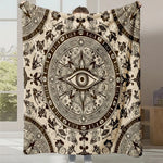 Motif ornemental détaillé en noir et blanc avec un oeil central symbole et des éléments décoratifs complexes.