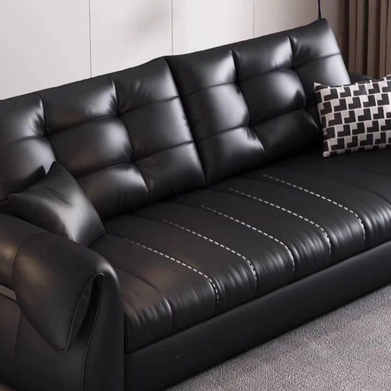 canapé lit noir simili cuir moderne coussin décoratif table basse tapis couverture
