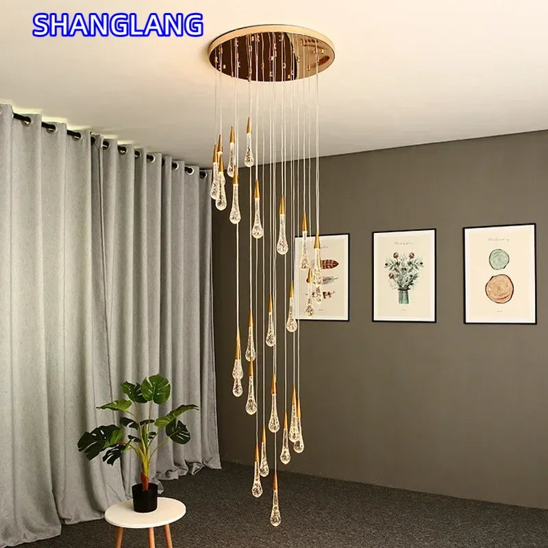 suspension lumineuse moderne gouttes cristal transparentes dorées élégante led acier inoxydable