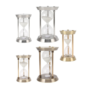 Sablier décoratif vintage en métal couleur or avec sable brillant sur table en bois