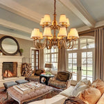 chandelier bronze classique suspension lumière abat jours tissu texturé courbes salle manger