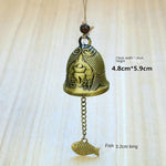 cloche décorative artisanale bronze doré ornements floraux poissons vintage pendentif métallique
