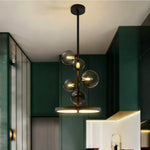 suspension lumineuse moderne sphères verre transparent anneaux métalliques noir doré grisclair