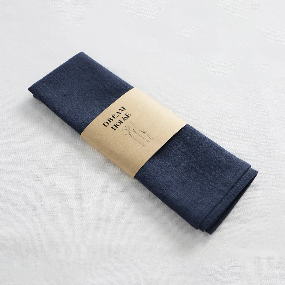 serviettes tissu pliées rustique bohème minimaliste liens anneaux couleurs beige rose vert bleu gris