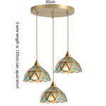 suspension lumineuse verre teinté art deco or marron bleu clair motifs géométriques opacité chaînes