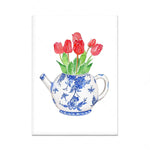 Une théière en porcelaine peinte à la main fleurie avec de magnifiques tulipes rouges.