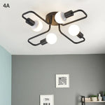 lampe suspension noir blanc moderne scandinave ampoules structure métallique fixations câbles noirs