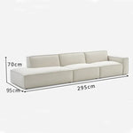 canapé d'angle moderne beige clair uni confortable salon minimaliste inclusion coussins tapis