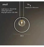 lumière suspendue moderne pendentif géométrique transparent cercles métalliques dorés chambre salon