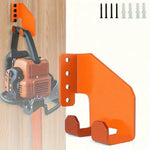 support mural industriel noir orange outils jardin vis cheville fixations robustes tronçonneuse pelles multifonctionnels