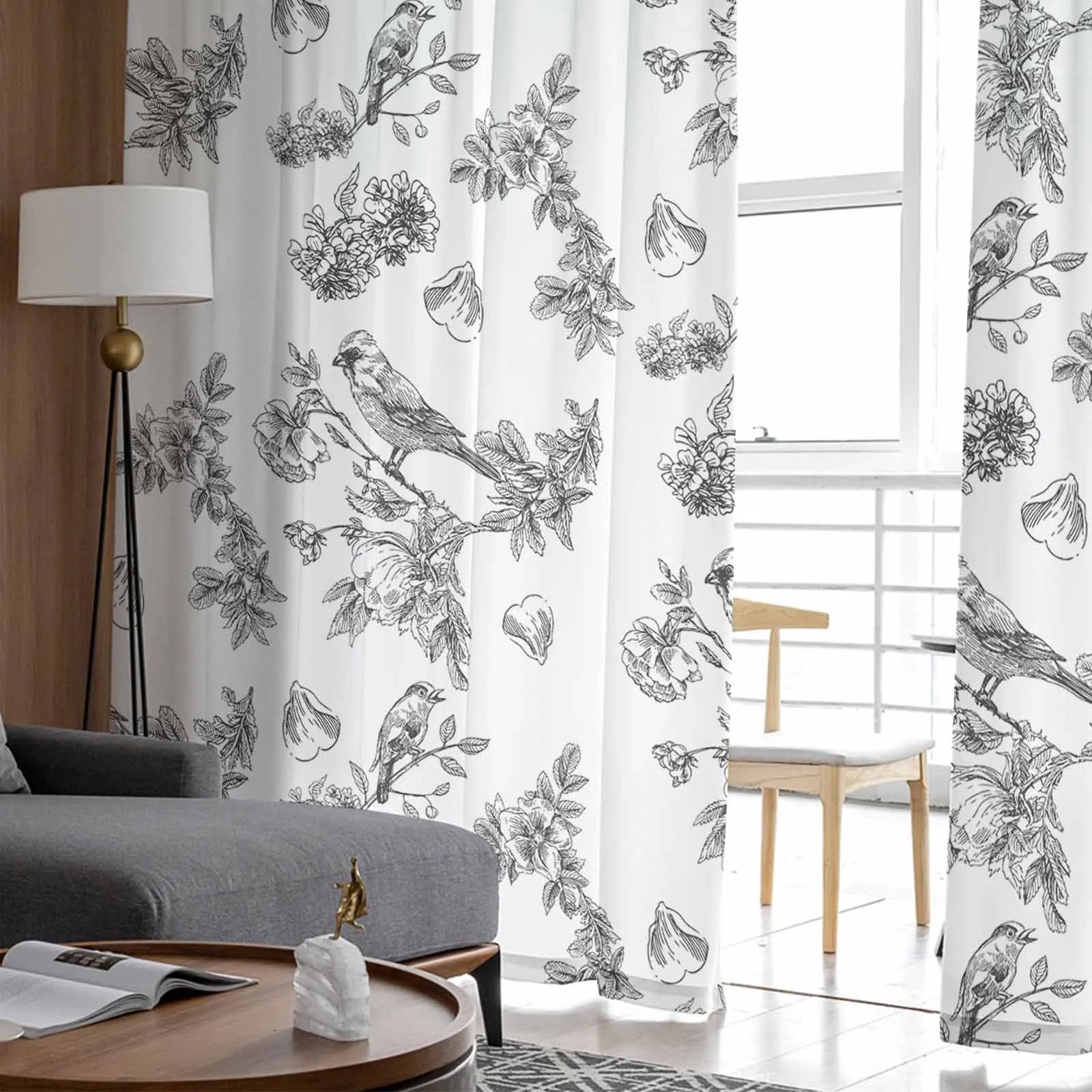 Rideau décoratif avec motifs floraux et oiseaux, idéal pour apporter une touche élégante à votre salon. Ce rideau imprimé en noir et blanc s'intègre parfaitement dans un intérieur moderne, accentuant votre décoration avec ses détails artistiques raffinés. Ce design apporte lumière et style à votre espace de vie, tout en offrant une ambiance naturelle et apaisante. Adapté pour le salon ou la salle à manger, il transforme votre pièce en un lieu chic et accueillant.