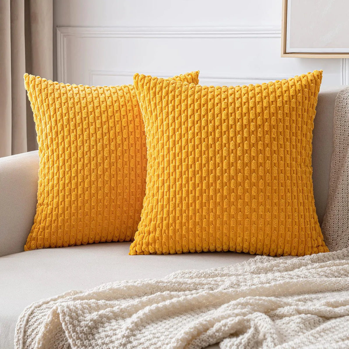 coussins carrés vert clair beige rose pâle texture tissée pompons moderne fermeture glissière