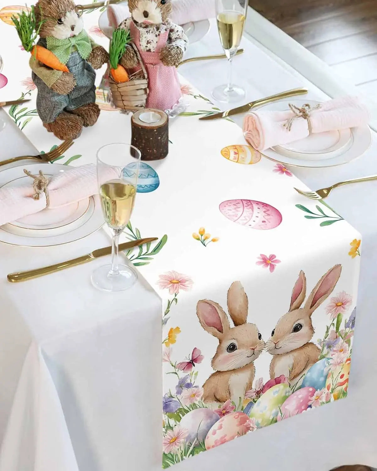 La table est décorée avec des figurines de lapins mignons et des motifs floraux printaniers, accompagnés de flûtes de champagne, dans une ambiance festive et élégante.