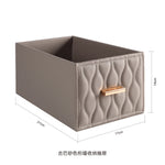 boîte rangement cuir matelassé poignées métalliques chambre moderne