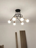 suspension lumineuse moderne noir doré ampoules blanches structure spirale fixation câbles métallique