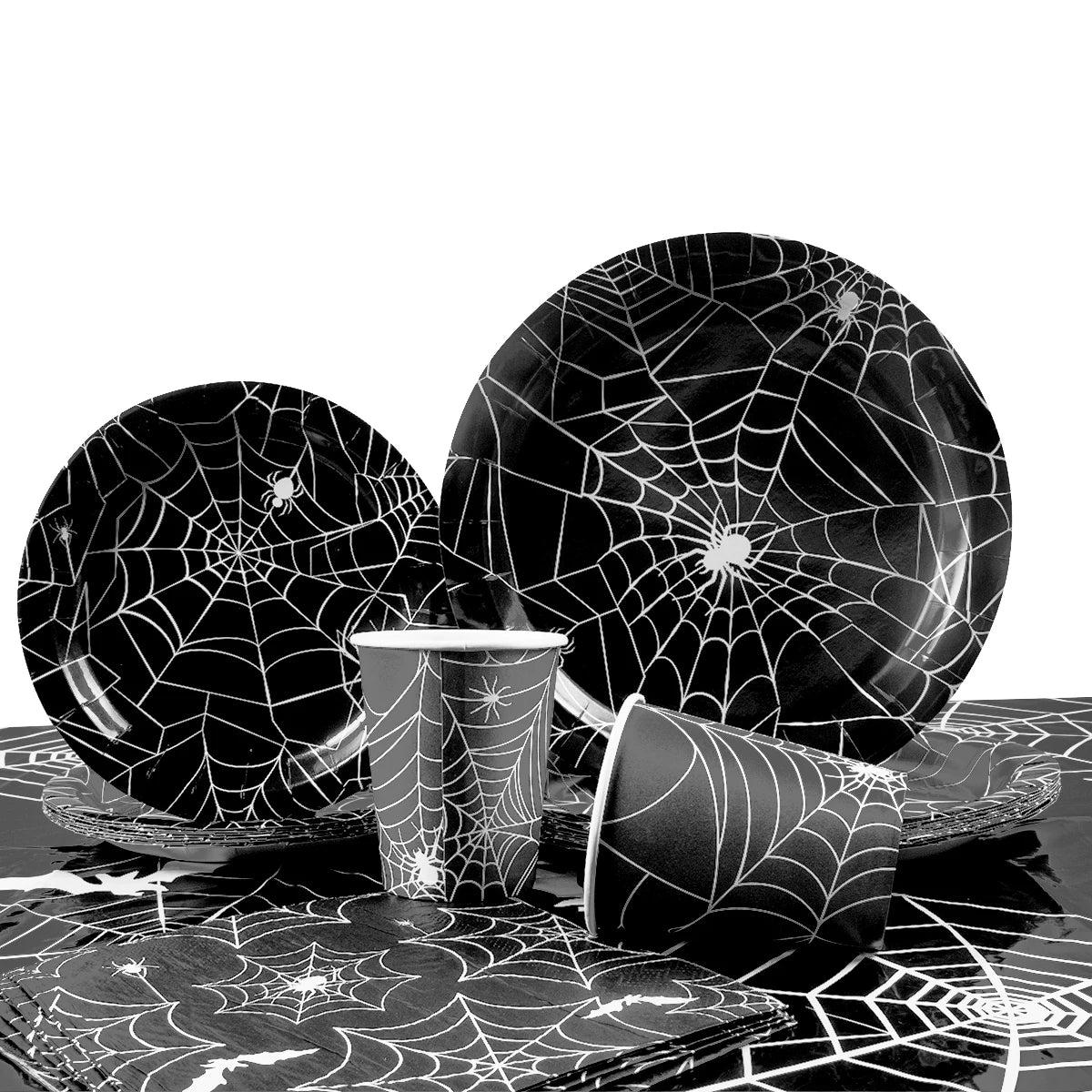 assiettes halloween araignées verres serviettes table noire blanc points brillants toile festive octobre