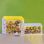Présentoir rangement jouets style maison toit vert foncé avec éclairage ambiant allumé