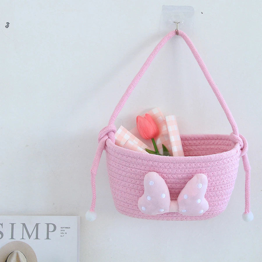 panier rangement rose blanc rayures horizontales noeud décoratif réutilisable polyestère enfantin cordelette organisation jouets