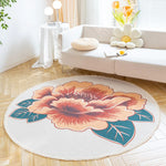 Un tapis rond beige décoré d'un magnifique motif de fleurs orange et verte qui apporte une touche de nature et de douceur à cet intérieur moderne et lumineux.