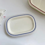 assiettes ovales rayées blanc bleu orange brun vaisselle classique décoration table servir plats après