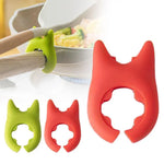 Repose-cuillère en silicone rouge organisant des spatules de cuisine