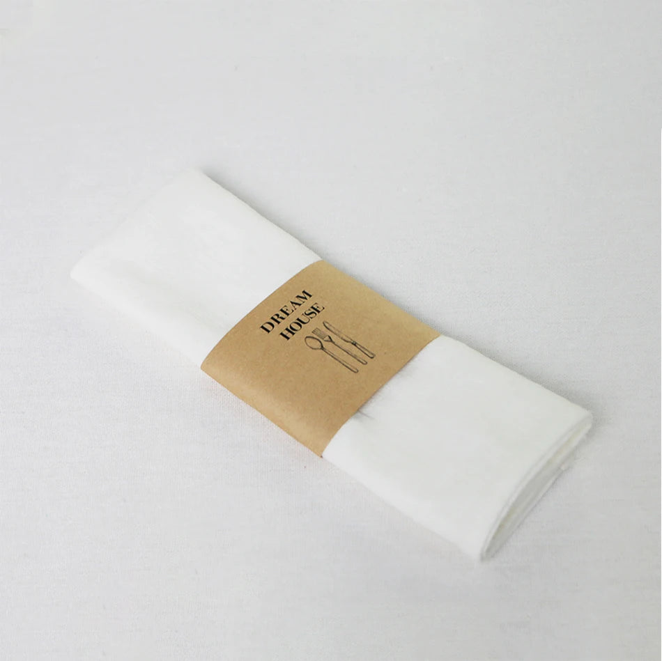 serviettes tissu pliées rustique bohème minimaliste liens anneaux couleurs beige rose vert bleu gris