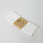 serviettes tissu pliées rustique bohème minimaliste liens anneaux couleurs beige rose vert bleu gris