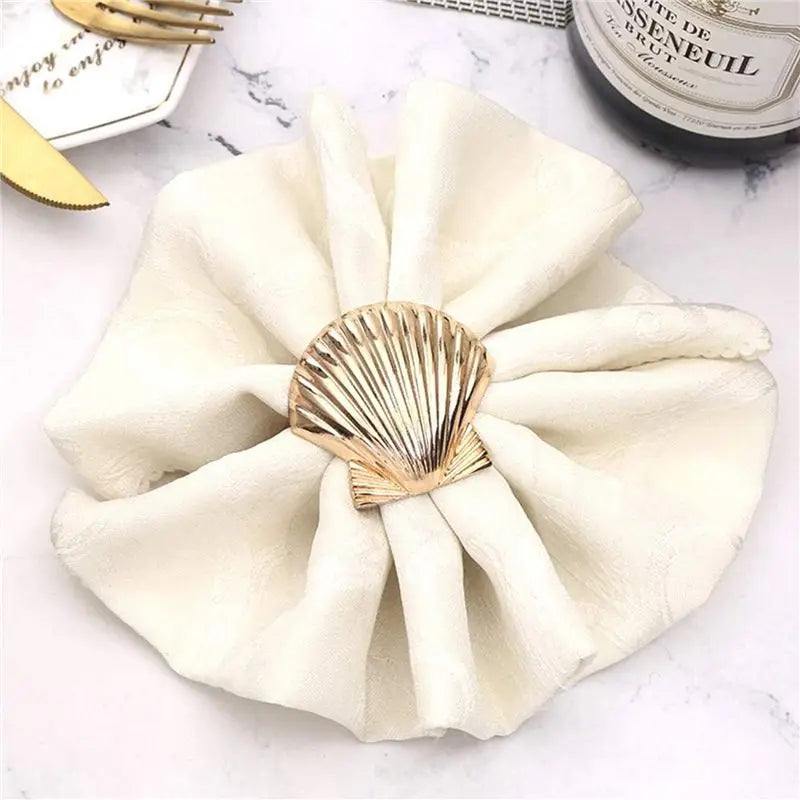 porte serviettes coquillage doré motif texturé marin élégant anneaux décoration table événement