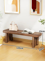 Banc bois marron clair texture naturelle moderne salon tabouret sac main livre ouvert decoration