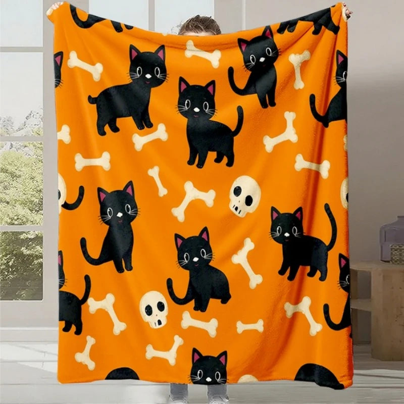 Couverture orange vif avec des motifs d'os et de chats noirs qui représentent un thème d'Halloween amusant et festif.