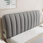 Tête de lit matelassée en velours doux gris sur un lit