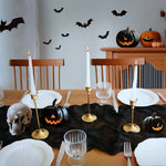 ruban table noir crêpe halloween décorations citrouilles crânes fourchettes assiettes bougies