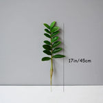 plantes artificielles branches vertes feuilles simples extérieur moderne pot blanc exposé