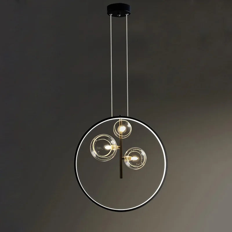 lumière suspendue moderne pendentif géométrique transparent cercles métalliques dorés chambre salon