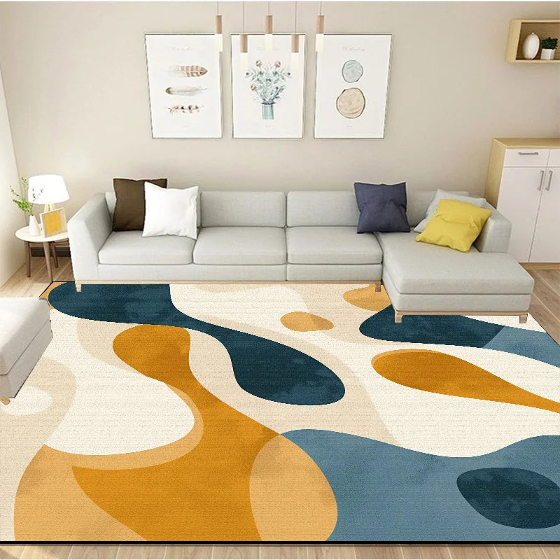 Un salon moderne et lumineux avec un canapé gris, des coussins colorés et des tableaux muraux, sur un tapis géométrique aux teintes automnales.