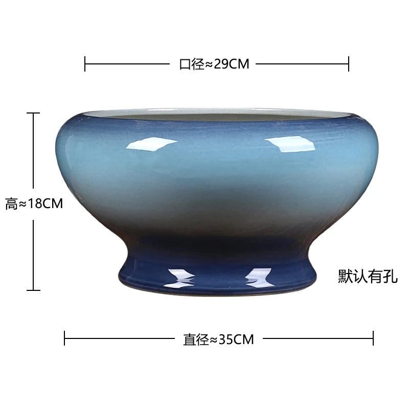 Bol décoratif en céramique ovale aux tons dégradés bleus et gris, mesurant environ 35 cm de large sur 18 cm de haut.